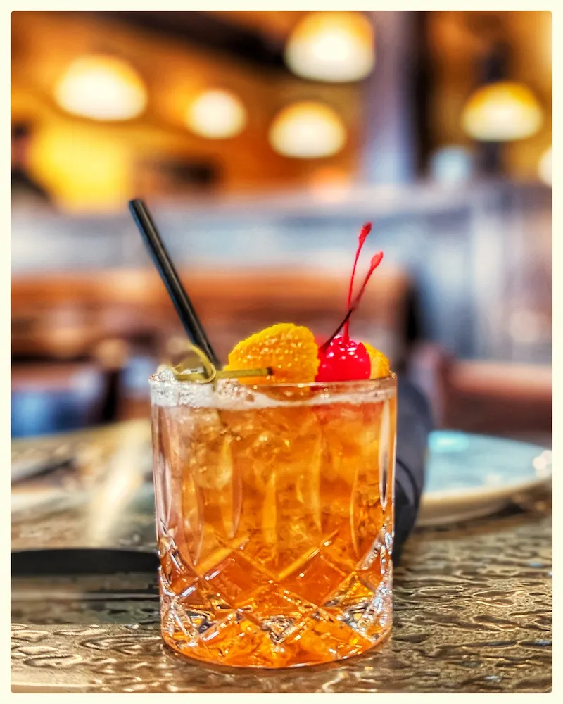 Chai Old Fashioned – Breckenridge Bourbon with Wild Moon Chai and Demerara Syrup, garnished with orange and cherry | SPICE ROOM Denver