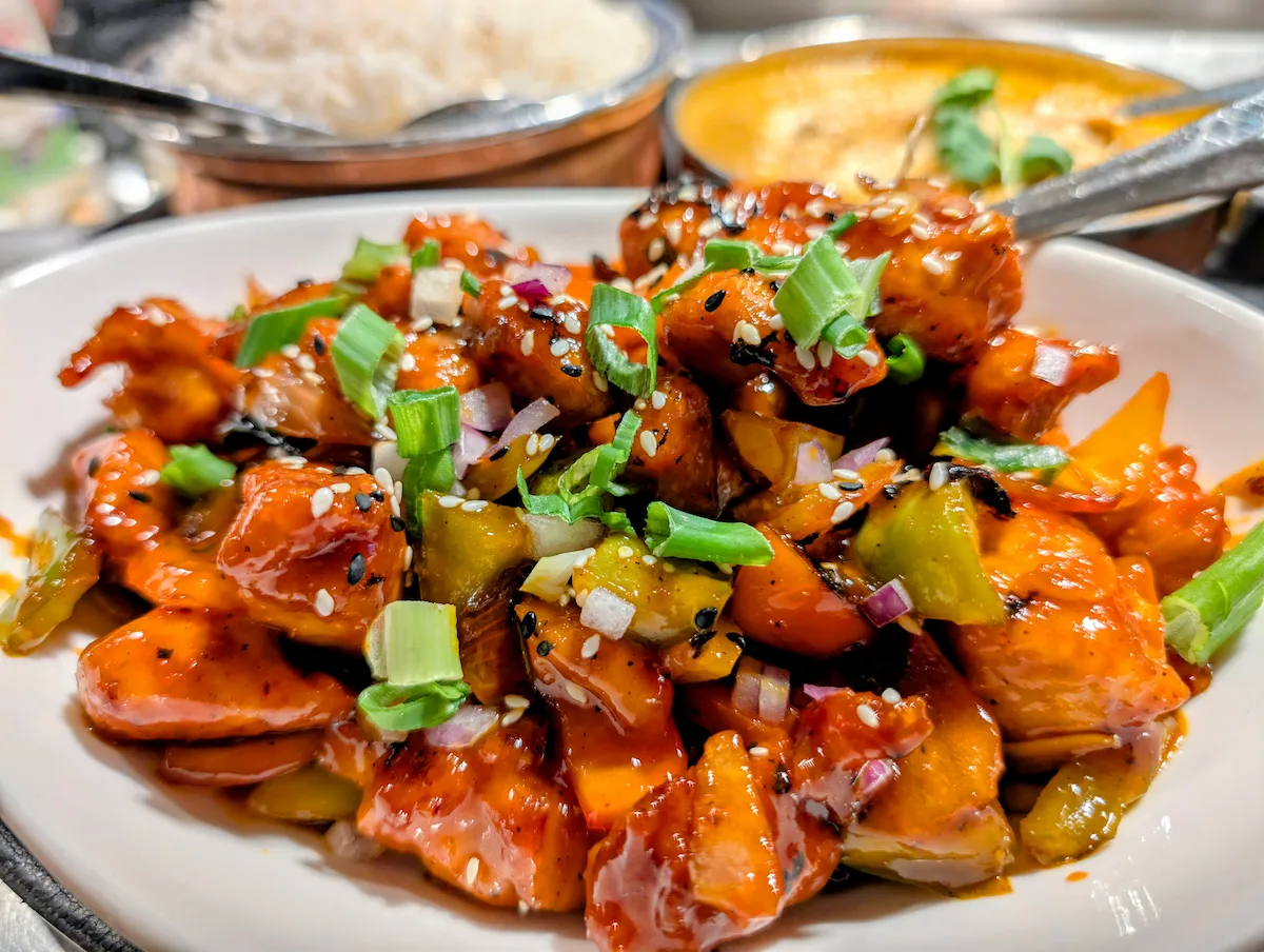 Chili Paneer – Indo-Chinese crispy paneer tossed in a fiery, tangy sauce with sesame and spring onion | SPICE ROOM Denver