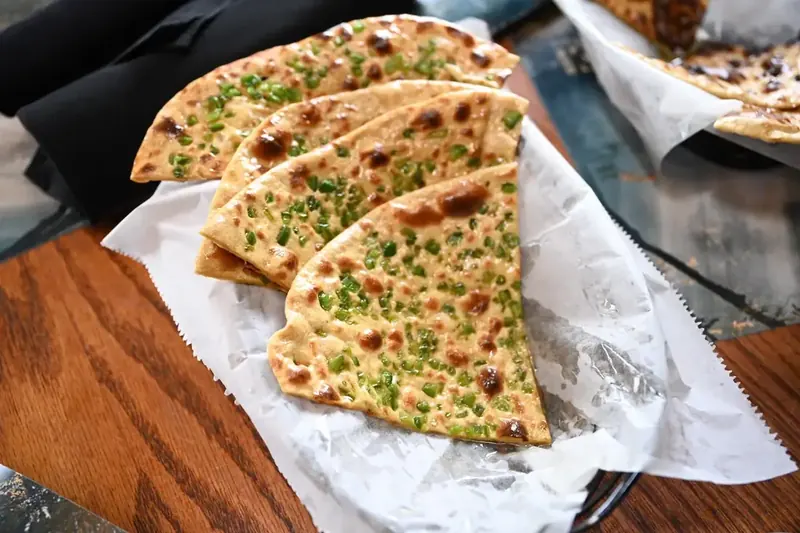 Potato Naan – Soft naan stuffed with seasoned mashed potato, baked in our clay tandoor. A hear | SPICE ROOM Denver