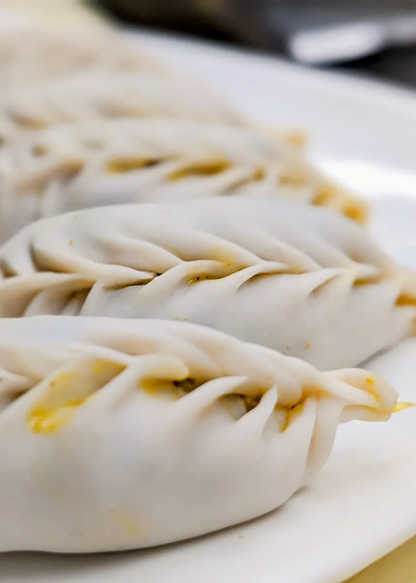 Momos – Himalayan-style steamed dumplings filled with spiced chicken or vegetables. | SPICE ROOM Denver