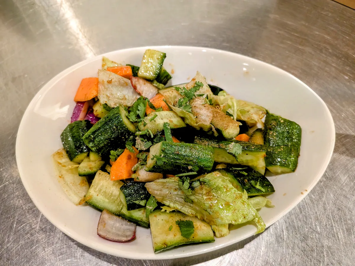 Indian Cucumber Salad – Crisp cucumber with red onion, tomato, and cilantro, tossed in Indian spices and drizzled with tangy tamarind sauce | SPICE ROOM Denver