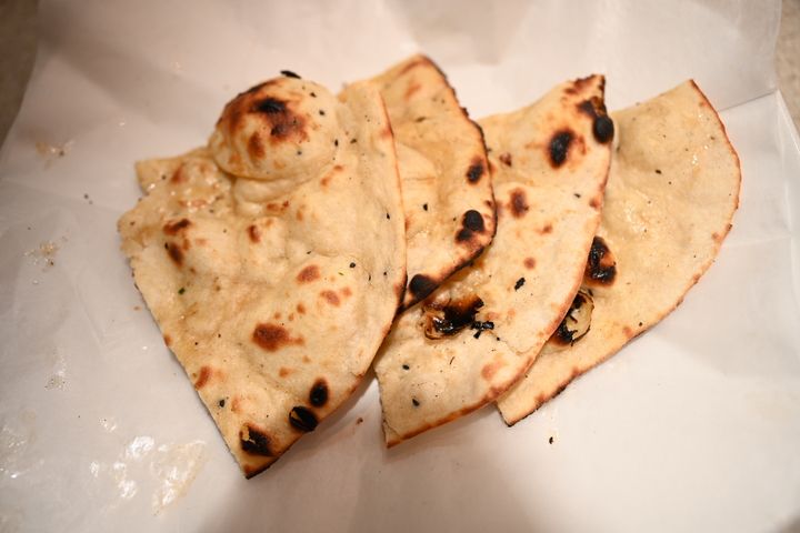 Butter Naan – Pillow-soft bread from our 500°F tandoor, blistered and beautiful, brushed with  | SPICE ROOM Denver