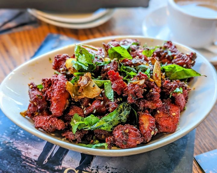 Chicken 65 – Deep-fried chicken bites marinated in fiery red chili, ginger, and curry leaves  | SPICE ROOM Denver