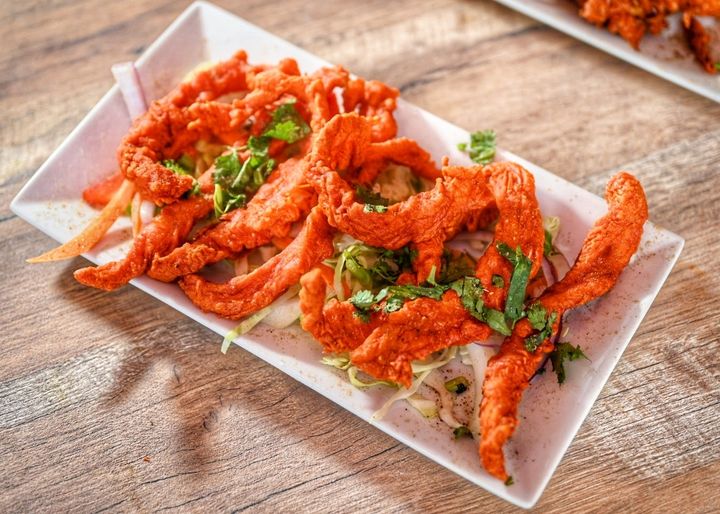 Chicken Pakora — Tender chicken pieces marinated in spices, coated in chickpe