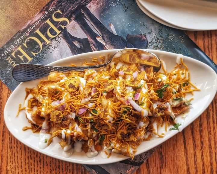 Dahi Papari – Crispy papdi wafers topped with potatoes, chickpeas, yogurt, and tangy-sweet chu | SPICE ROOM Denver
