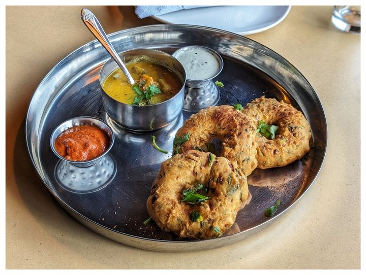 Medu Vada – Golden, crispy donut-shaped fritters made from urad dal batter. South India's cr | SPICE ROOM Denver