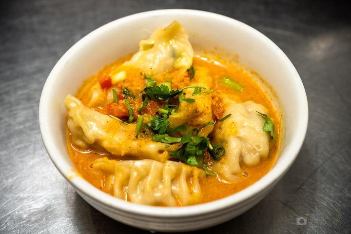 Momo Soup — Pillowy dumplings swimming in a fiery sesame-tomato broth – 
