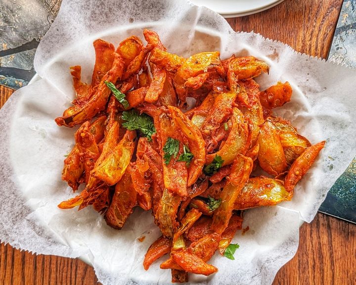 Onion Bhaji — Thinly sliced onions in spiced chickpea batter, fried until 
